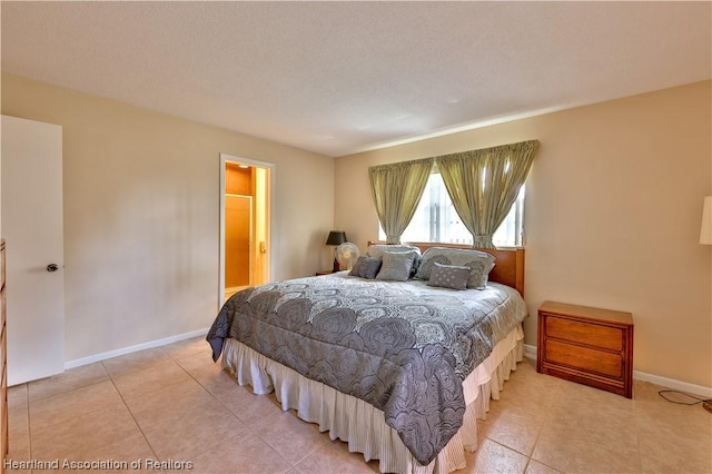 bedroom featuring light tile patterned floors and a textured ceiling