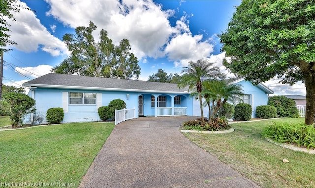 single story home with a front lawn and covered porch