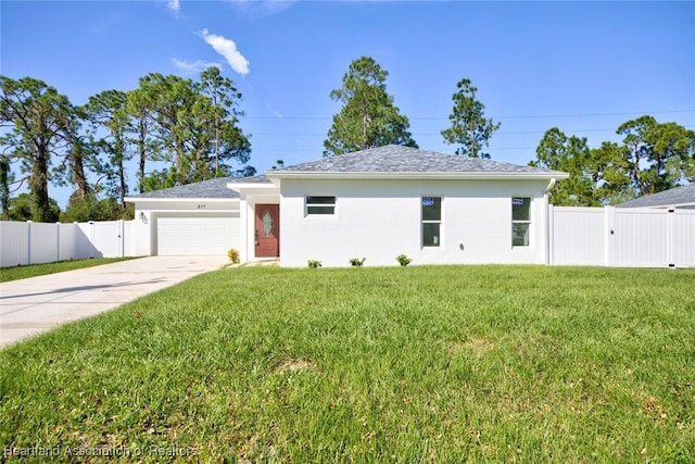 view of front of property featuring a garage and a front lawn