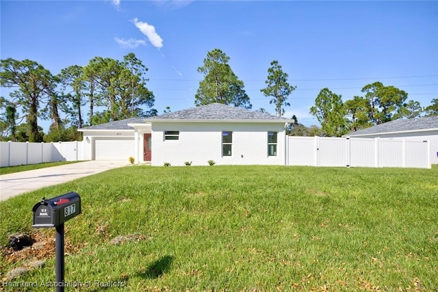 view of front facade with a front yard and a garage