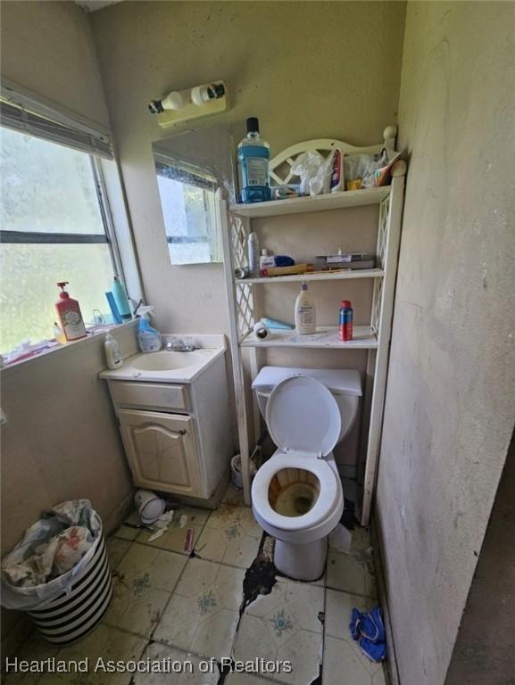 bathroom with tile patterned floors, vanity, and toilet