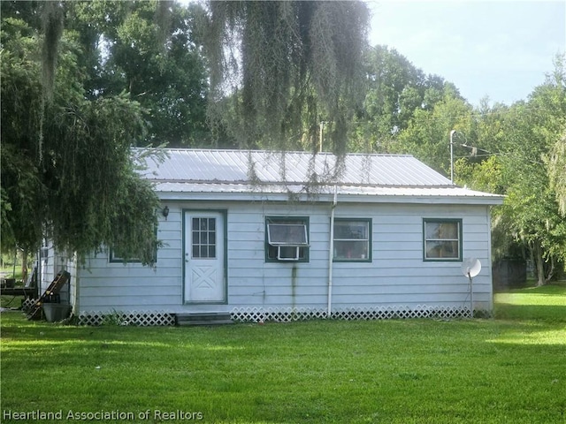 rear view of house with a yard