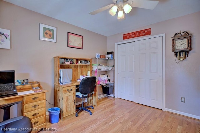 office with light wood finished floors, ceiling fan, and baseboards