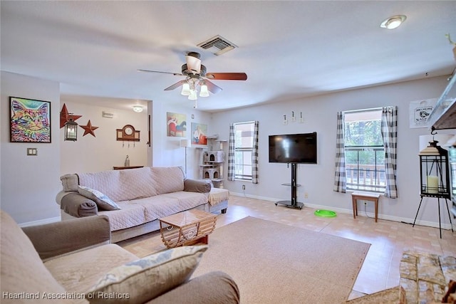 living room with ceiling fan, visible vents, and baseboards