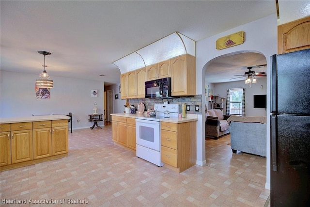 kitchen featuring arched walkways, light countertops, decorative backsplash, black appliances, and decorative light fixtures