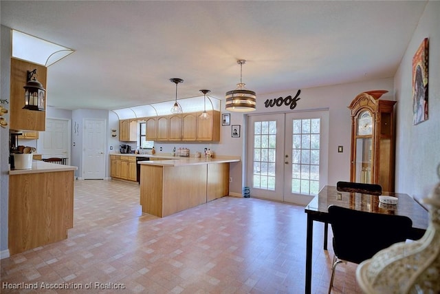 kitchen with light brown cabinets, a peninsula, french doors, and light countertops