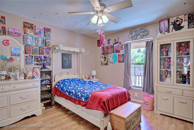 bedroom with light wood-style flooring and ceiling fan