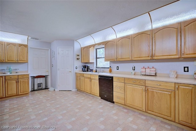 kitchen with a sink, visible vents, baseboards, light countertops, and dishwasher