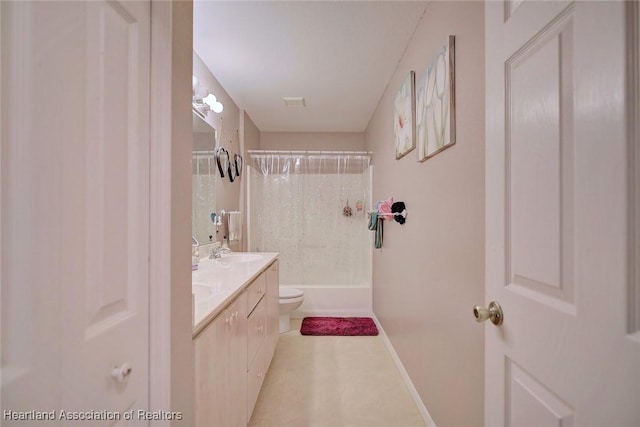 bathroom with double vanity, shower / bath combination with curtain, toilet, a sink, and baseboards