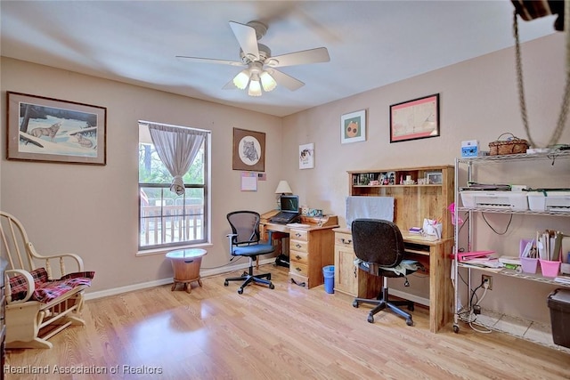 office with light wood-style floors, baseboards, and a ceiling fan