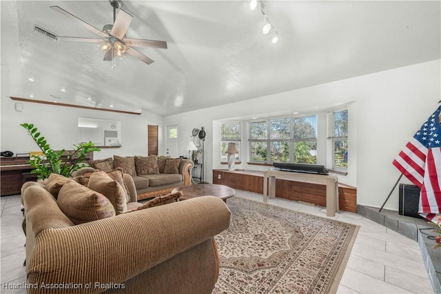 living room featuring light tile patterned flooring, lofted ceiling, track lighting, and ceiling fan