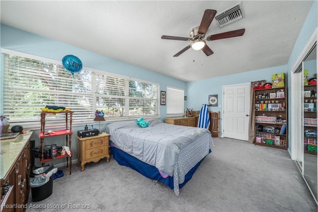 bedroom featuring light colored carpet and ceiling fan