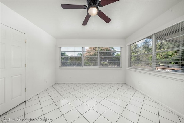 interior space featuring light tile patterned floors and ceiling fan