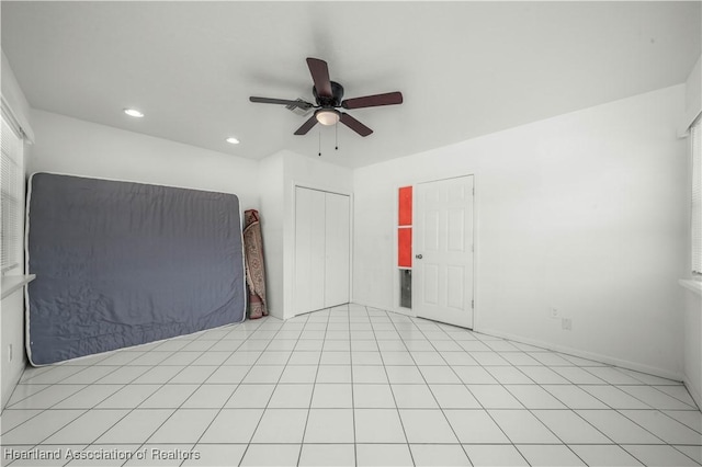 tiled spare room with ceiling fan