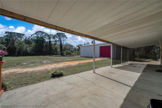 view of patio featuring a garage and an outdoor structure