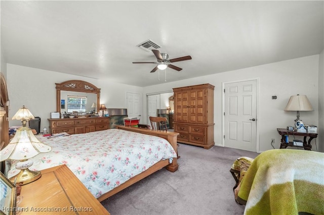 carpeted bedroom with ceiling fan and a closet