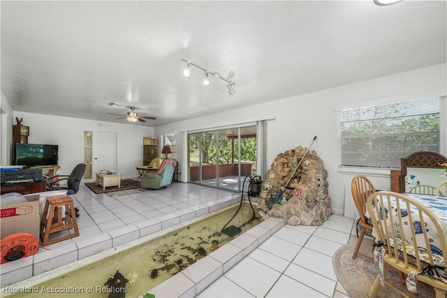 interior space with ceiling fan