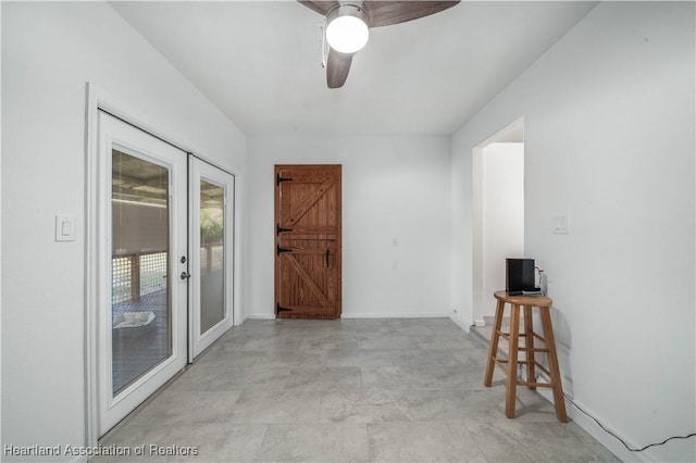 spare room with ceiling fan and french doors