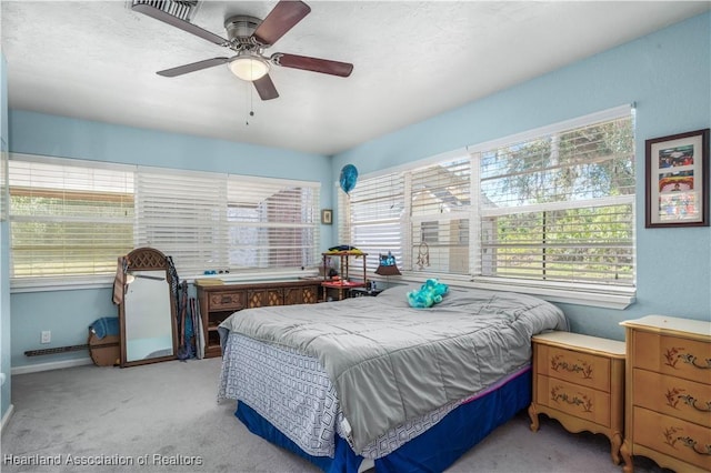 bedroom featuring light colored carpet and ceiling fan