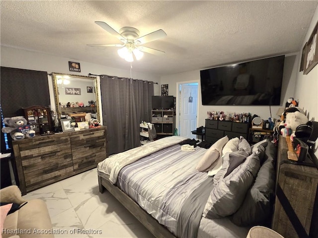 bedroom with a textured ceiling and ceiling fan