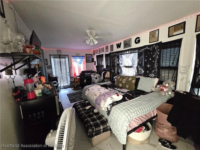 bedroom with multiple windows and ceiling fan