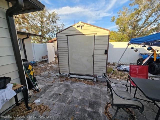 view of patio / terrace featuring a shed