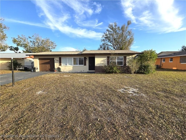 single story home featuring a garage and a front yard