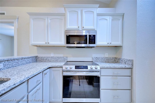 1465 Berwin Ave, Avon Park, FL 33825 - kitchen featuring appliances with stainless steel finishes, white cabinets, and light stone countertops
