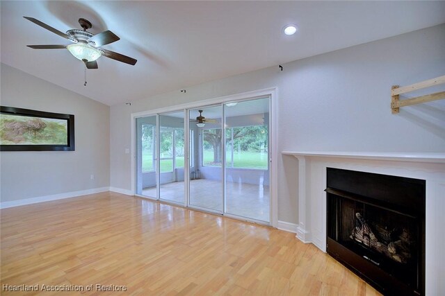 1465 Berwin Ave, Avon Park, FL 33825 - unfurnished living room featuring a ceiling fan, vaulted ceiling, wood finished floors, a fireplace, and recessed lighting