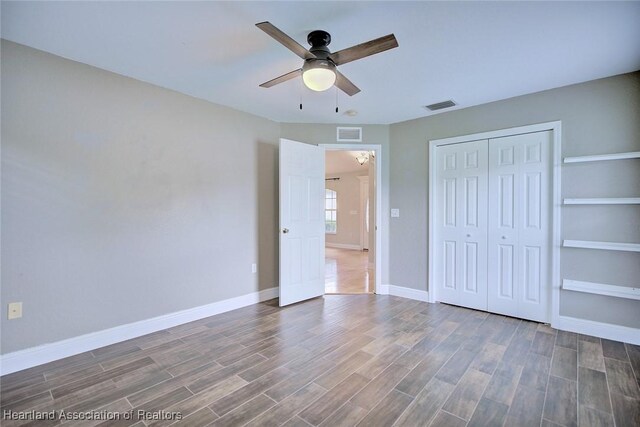1465 Berwin Ave, Avon Park, FL 33825 - unfurnished bedroom with wood finished floors, a closet, and ceiling fan