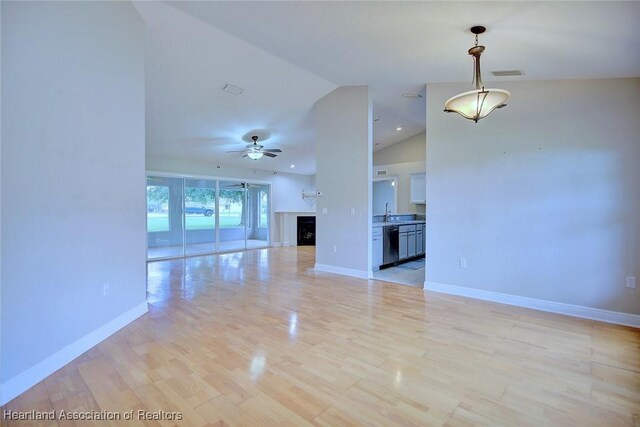 1465 Berwin Ave, Avon Park, FL 33825 - unfurnished living room featuring ceiling fan, lofted ceiling, and light wood-type flooring