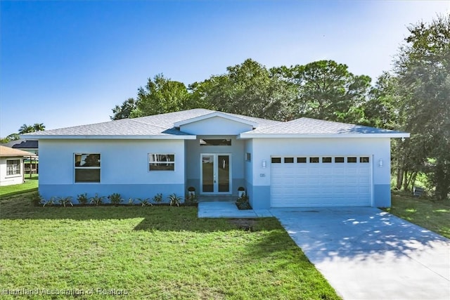 view of front of house featuring french doors, a front yard, and a garage