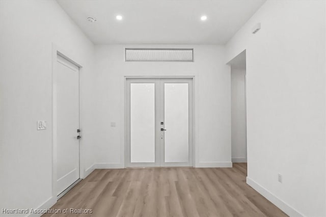 interior space with french doors and light hardwood / wood-style floors