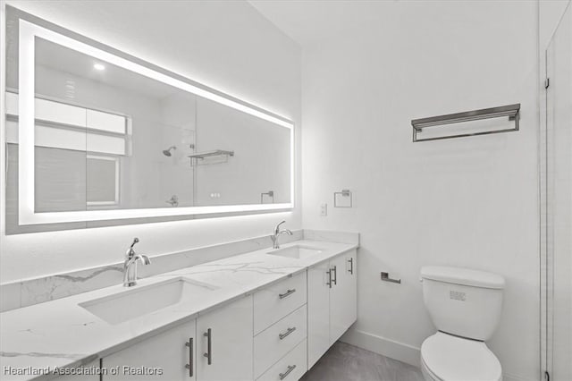 bathroom featuring toilet, a shower, and vanity