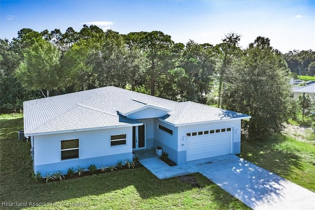 view of front of property with a front yard and a garage