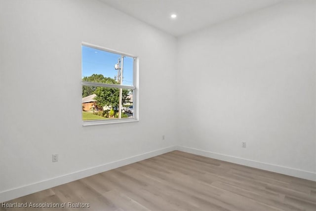 spare room featuring light hardwood / wood-style flooring