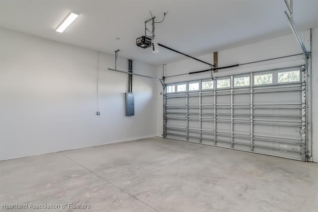 garage with a garage door opener and electric panel