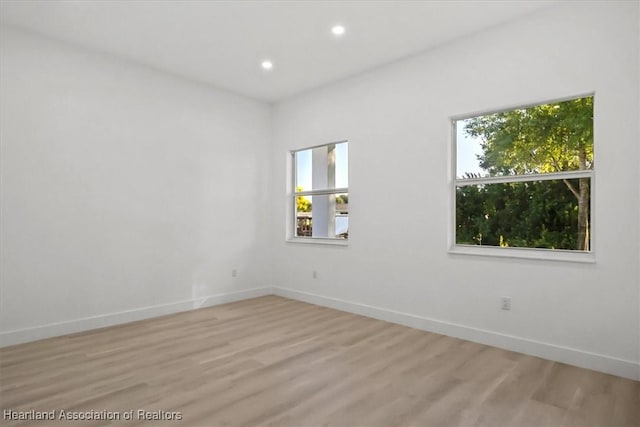 empty room with light hardwood / wood-style flooring