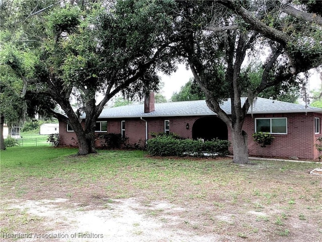 136 Hallmark Ave, Lake Placid, FL 33852 - single story home with brick siding and a chimney