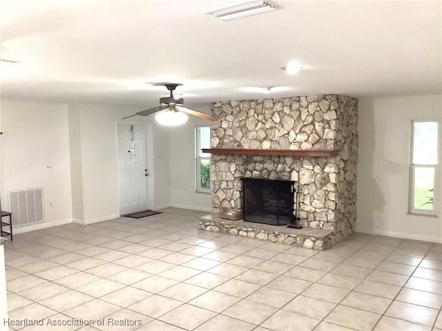 136 Hallmark Ave, Lake Placid, FL 33852 - unfurnished living room featuring healthy amount of natural light, a fireplace, and light tile patterned floors