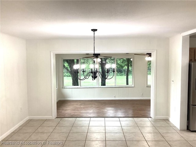 136 Hallmark Ave, Lake Placid, FL 33852 - unfurnished dining area with a chandelier, light tile patterned flooring, and baseboards