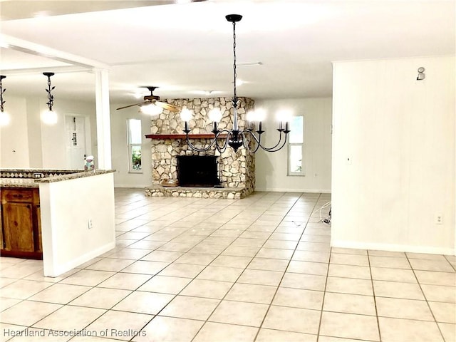 136 Hallmark Ave, Lake Placid, FL 33852 - unfurnished living room featuring light tile patterned flooring, a stone fireplace, a ceiling fan, and baseboards