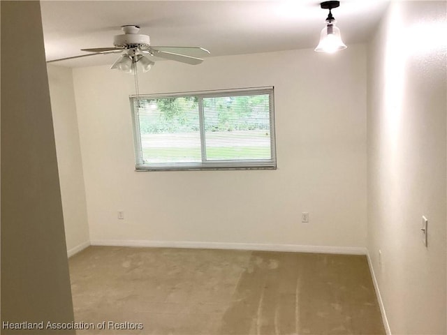136 Hallmark Ave, Lake Placid, FL 33852 - spare room featuring light carpet, a ceiling fan, and baseboards