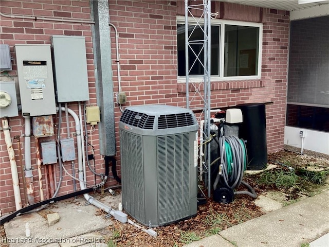 136 Hallmark Ave, Lake Placid, FL 33852 - exterior view of central AC unit, brick siding, and electric meter