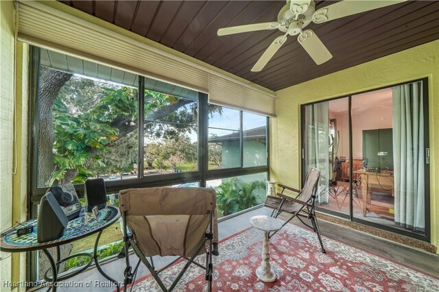 sunroom / solarium featuring ceiling fan and wooden ceiling