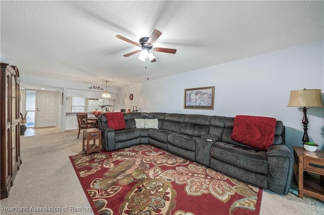 carpeted living room featuring a textured ceiling and ceiling fan