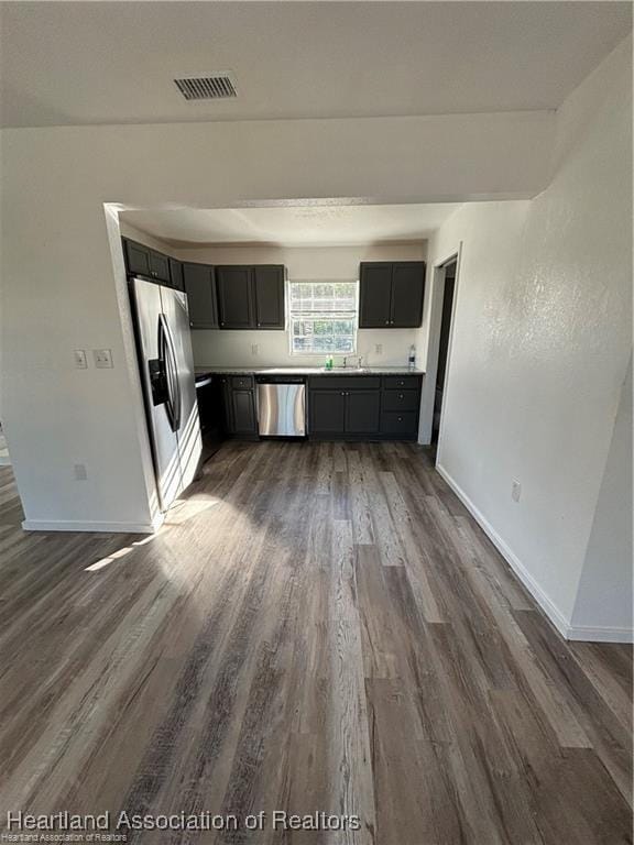 kitchen with dark wood-type flooring, visible vents, and appliances with stainless steel finishes