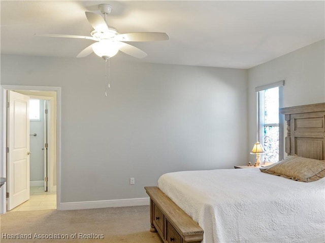 bedroom featuring ceiling fan and light carpet