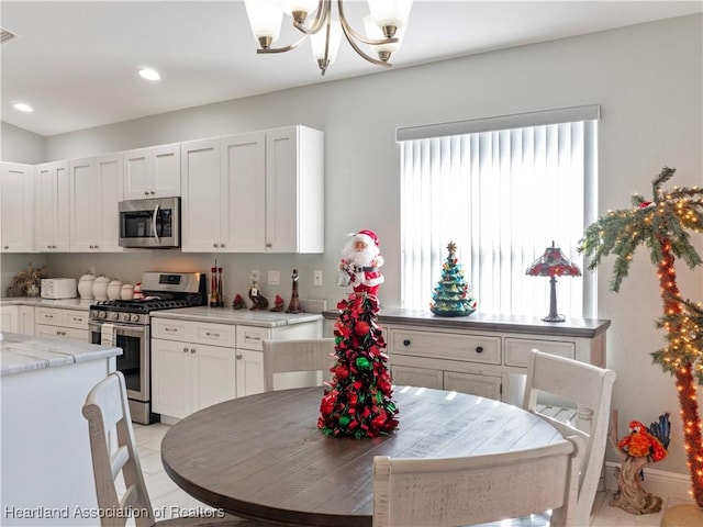 kitchen featuring plenty of natural light, white cabinetry, and appliances with stainless steel finishes