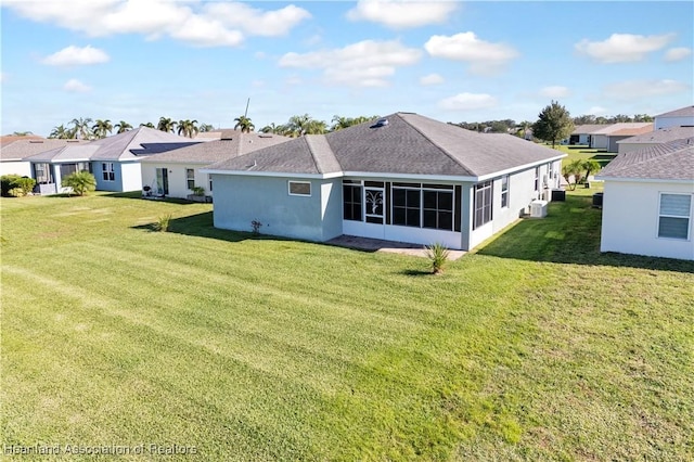 back of house featuring a sunroom and a yard